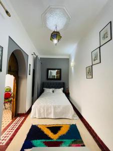 a bedroom with a bed and a rug on the floor at Archduke private rooms in Marrakech