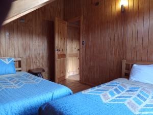 Postel nebo postele na pokoji v ubytování Cabaña piedra azul