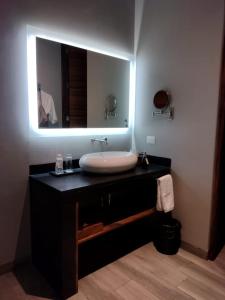 a bathroom with a sink and a mirror at El Callejón Hotel Boutique in Oaxaca City