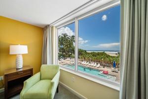 a room with a large window with a view of a resort at Luxury Beach Front Resort in Fort Myers Beach
