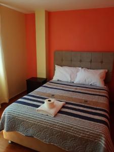 Rúm í herbergi á Hostal Ayllu