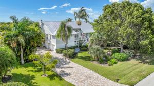 an aerial view of a white house with palm trees at PEARL OF SANIBEL-Brand New to Rentals! in Sanibel