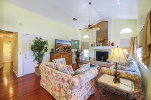 a living room with two couches and a fireplace at PEARL OF SANIBEL-Brand New to Rentals! in Sanibel