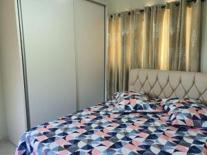 a bedroom with a bed with a checkered blanket at Casa Damasco in Florianópolis