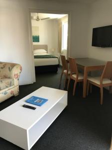 a living room with a couch and a table at Portobello Resort Apartments in Gold Coast