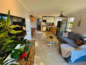 a living room with a couch and a table at Broadbeach, Stylish Apartment Close To everything in Gold Coast
