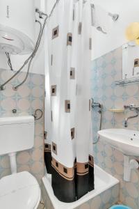 uma casa de banho com um chuveiro, um WC e um lavatório. em Studio Pokrivenik 5231d em Gdinj