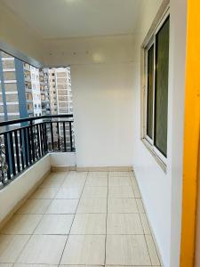 a balcony with a view of a building at Eastleigh Executive Furnished Apartments next to BBS Mall in Nairobi