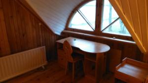 a small table in a room with a window at Saare Guest Apartment in Saare