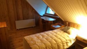 1 dormitorio con cama, mesa y ventana en Saare Guest Apartment, en Saare