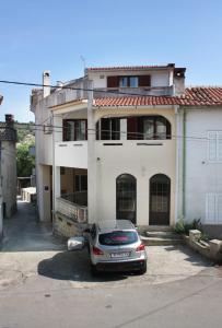 a car parked in front of a house at Apartments and rooms with parking space Vrbnik, Krk - 5302 in Vrbnik