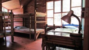 a room with bunk beds and a desk with a lamp at Centro Ecológico Montaña Verde in Rivas +32 photos