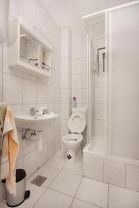 a white bathroom with a toilet and a sink at Apartments and rooms with parking space Sveti Vid, Krk - 5323 in Sveti Vid-Miholjice