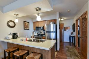 a kitchen with a sink and a refrigerator at Divine 9 Condo - Resort Amenities - Fishing Lake - Hiking Trails - So Comfy!! in Reeds Spring
