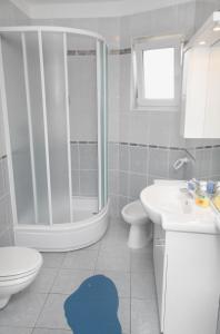 a bathroom with a shower and a toilet and a sink at Apartments by the sea Njivice, Krk - 5296 in Njivice