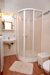 a bathroom with a shower and a toilet and a sink at Double Room Krk 5294b in Krk