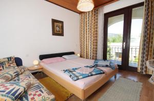 a bedroom with a bed and a window at Apartments with a parking space Baska, Krk - 5430 in Baška