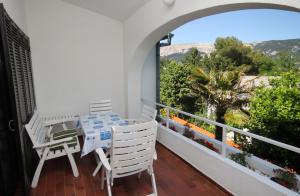 a balcony with a table and chairs and a view at Apartments with a parking space Baska, Krk - 5430 in Baška
