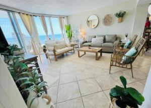 a living room with a couch and a table at Beach Oasis 704 Lovely Daytona ocean front for 5 sleeps up to 12 in Daytona Beach
