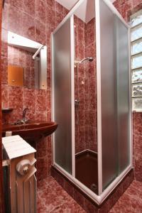 a shower with a glass door in a bathroom at Apartments by the sea Njivice, Krk - 5311 in Njivice