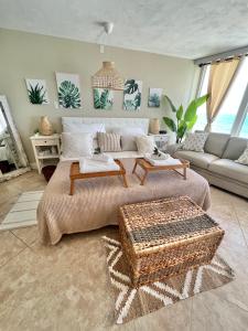a living room with a large bed and a couch at Beach Oasis 704 Lovely Daytona ocean front for 5 sleeps up to 12 in Daytona Beach