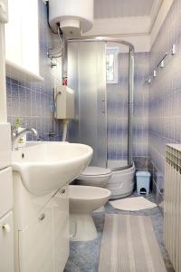 a bathroom with two toilets and a sink and a shower at Apartments with a parking space Selce, Crikvenica - 5495 in Selce