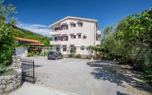 a car parked in front of a building at Apartments with a swimming pool Baska, Krk - 5354 in Baška