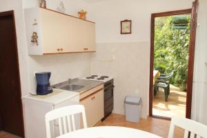 a kitchen with a sink and a stove at Apartments by the sea Dramalj, Crikvenica - 5522 in Dramalj