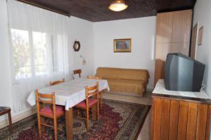 a living room with a table and a tv at Apartment Krk 5318a in Krk