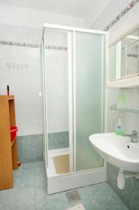 a bathroom with a shower and a sink at Apartments with a parking space Pinezici, Krk - 5319 in Pinezici