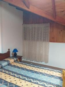 a bedroom with two beds and a window at Casa sur 3 (faro norte) in Mar del Plata