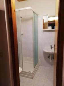 a bathroom with a shower and a toilet and a sink at Apartment Njivice 5398a in Njivice