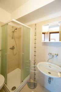 a bathroom with a glass shower and a sink at Apartments and rooms with parking space Njivice, Krk - 5398 in Njivice