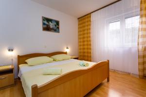a bedroom with a bed and a large window at Apartments with a parking space Kornic, Krk - 5306 in Kornić
