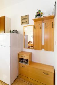 a kitchen with a white refrigerator and a mirror at Apartment Kornic 5306b in Kornić