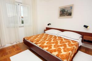 a bedroom with a bed in a room at Apartments by the sea Vantacici, Krk - 5347 in Malinska