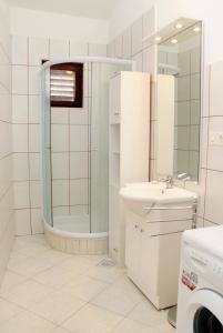 łazienka z prysznicem i umywalką w obiekcie Apartments by the sea Punat, Krk - 5328 w mieście Punat