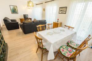 a living room with a table and chairs at Apartments with a parking space Smrika, Kraljevica - 5508 in Šmrika