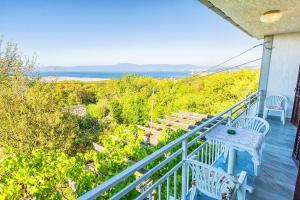 a porch with a table and chairs and the ocean at Apartments with a parking space Smrika, Kraljevica - 5508 in Šmrika