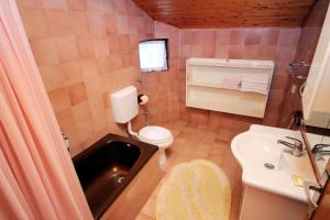 a small bathroom with a sink and a toilet at Apartments with a parking space Punat, Krk - 5428 in Punat