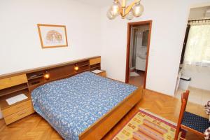 a bedroom with a bed and a dresser at Apartments with a parking space Punat, Krk - 5428 in Punat