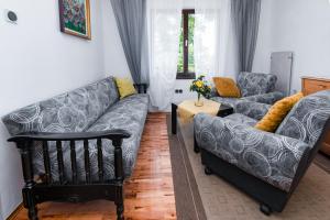 a living room with two couches and a table at Apartment Punat 5351a in Punat
