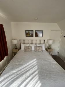 a bedroom with a large bed with two lamps at June Lake Villager in June Lake