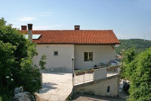 a large white house with a red roof at Apartments with a parking space Vrbnik, Krk - 5392 in Vrbnik