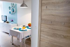 a dining room with a table and a wooden door at Apartments with a parking space Vrbnik, Krk - 5392 in Vrbnik