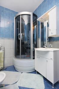 a bathroom with a shower and a sink at Apartments with a parking space Punat, Krk - 5350 in Punat