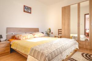 a bedroom with a large bed and a mirror at Apartments and rooms with WiFi Njivice, Krk - 5362 in Njivice