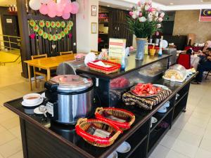 a buffet in a restaurant with food on it at Hotel Yt Midtown Kuala Terengganu in Kuala Terengganu