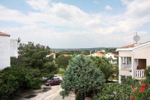 arial view of a residential neighbourhood with trees and cars at Apartments and rooms with parking space Punat, Krk - 5363 in Punat