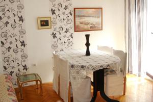 a table with a vase on it in a room at Apartments with a parking space Vantacici, Krk - 5386 in Malinska +37 photos